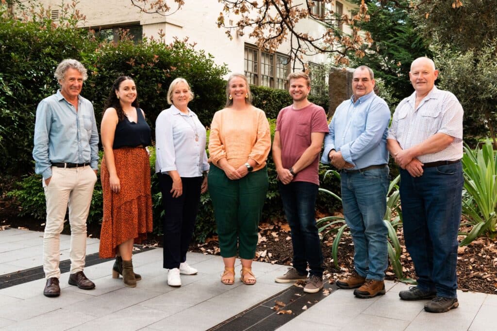 Group of people standing together having their photo taken